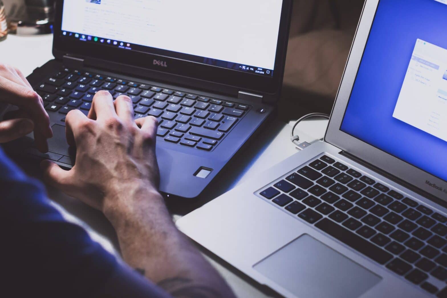 close up hands typing laptop