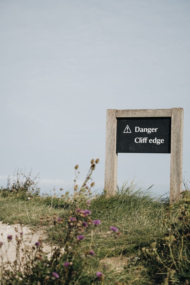 beach cliff danger sign