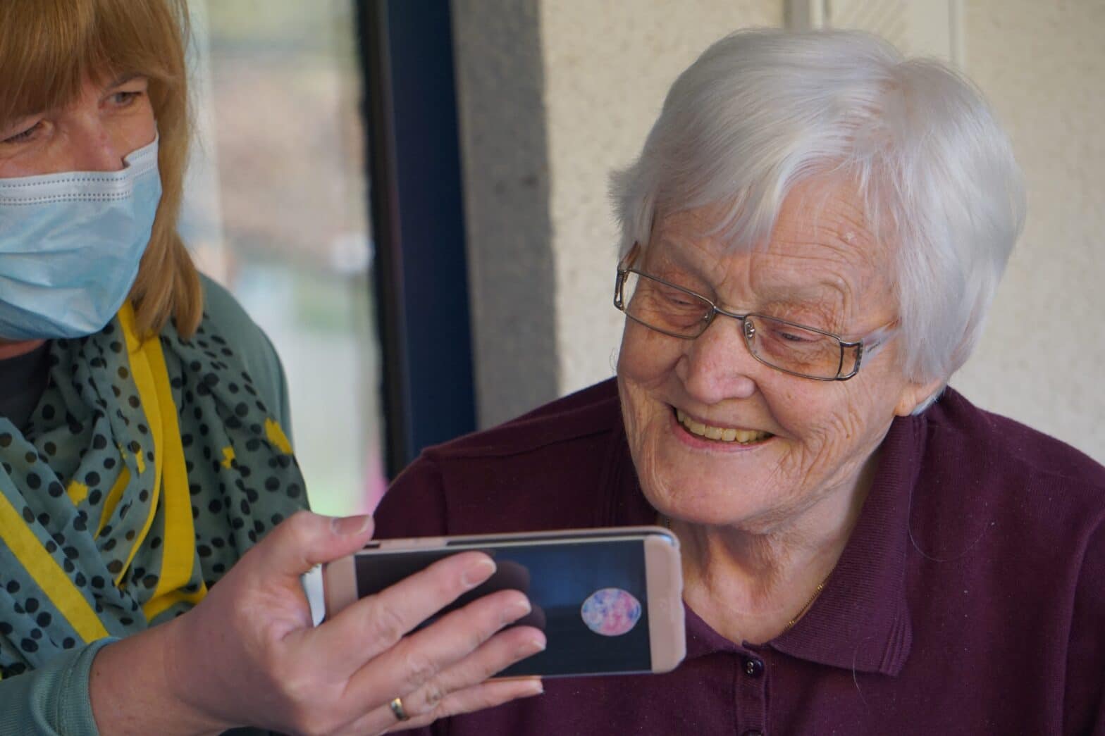 senior watching video on a phone