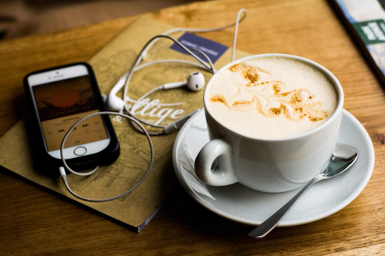 coffee cup and phone playing podcast